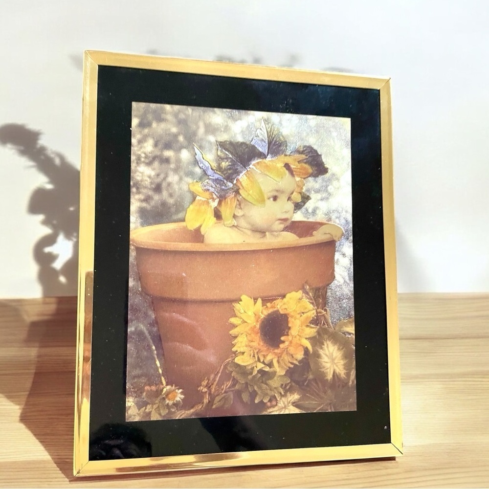 Charming vintage print of a baby in a flower pot. Foil print from 1980’s or 90’s
